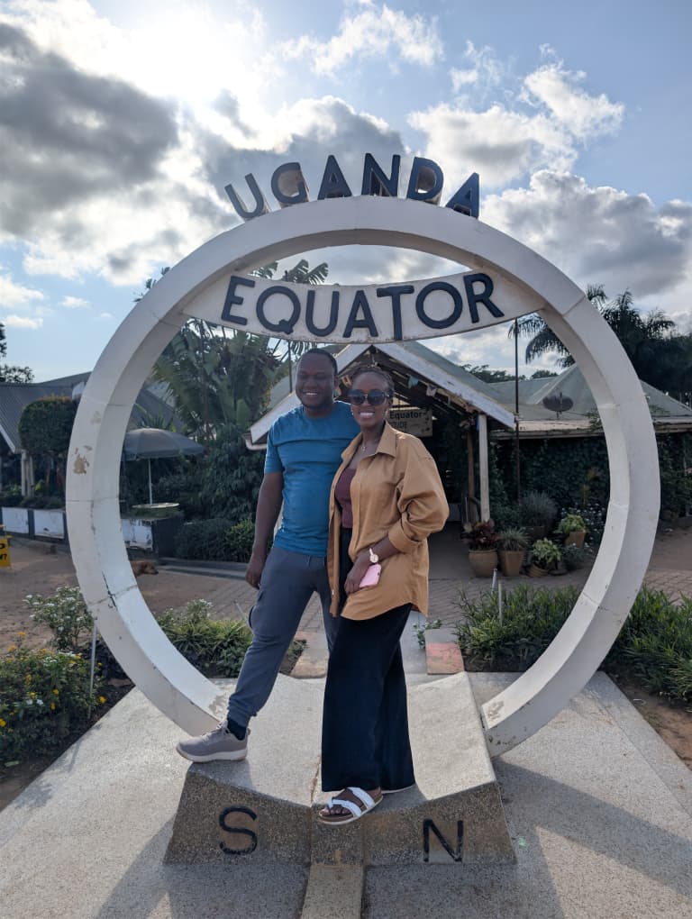 Brian and Angella standing inside the Uganda Equator monument on a bright day