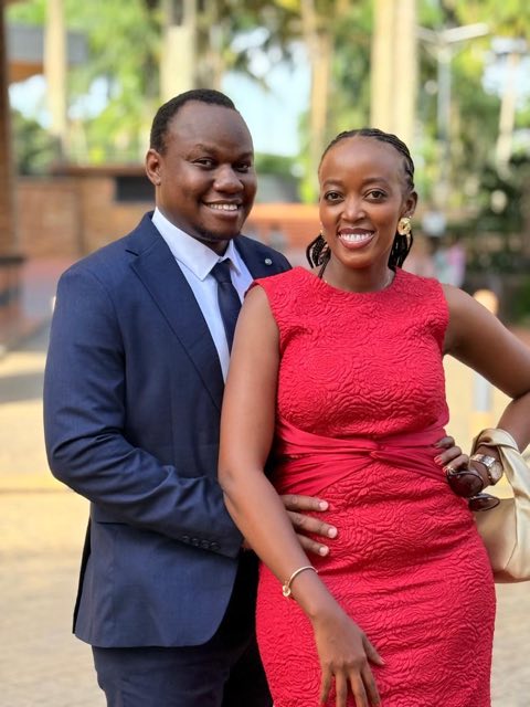 Brian in a navy suit with Angella in a red dress