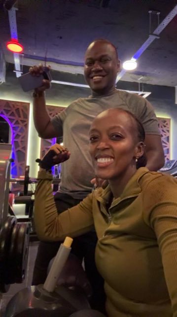 Brian and Angella grinning during a workout at the gym